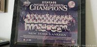Full front view of framed 1998 New York Yankees World Series Champions team photo plaque showing team members and titles.