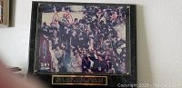 Framed plaque with photo of 1999 New York Yankees team celebrating World Series victory.