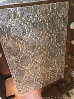 Full view of rectangular area rug laid out on wood flooring, showing overall pattern and condition.