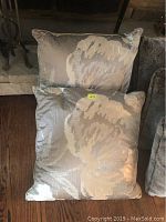 Two pillows stacked, showing floral abstract pattern and size ratio