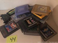 Top view showing a pile of Gameboy cartridges in various colored plastic cases, including yellow and purple Pokemon game cartridges.