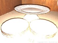 Overview photo showing one pedestal cake plate and eight smaller cake plates stacked