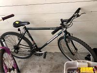 Full view of the Mongoose Alta mountain bike showing frame, saddle, wheels, and pedals.