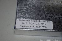 Close-up of box label detailing Freshwater Pearl Illusion Set with vendor and item numbers