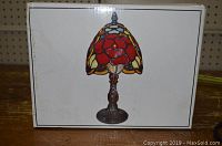 Box image showing stained glass Tiffany lamp image on front.
