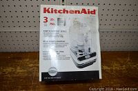 Front of KitchenAid box showing the product image and brand with model number KFC100CR.