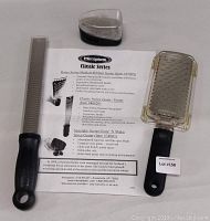 Photo showing three Microplane Classic Series graters with original instructions sheet detailing product features and model numbers.