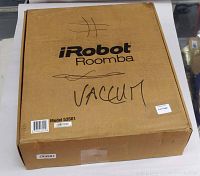 Sealed cardboard box labeled iRobot Roomba with handwritten “VACUUM” and printed Model 53501 sticker