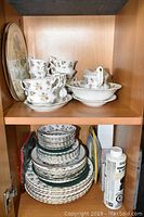 Upper cabinet with cups, saucers, creamer, sugar bowl and large serving platter