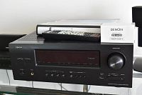 Denon AVR-1912 receiver front view with remote control, owner's manual, and boxed Denon DM-A409 Audyssey microphone on top
