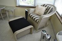 Armchair and ottoman side by side in a sunroom