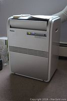 Front view of AC unit powered on showing digital display reading 75°F