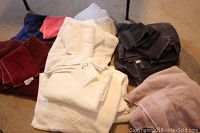 Grouped photo of assorted towels in white, burgundy, dark brown, pink, and coral.