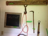 Yoke mounted on the wall above chalk board, cane hanging on pegboard