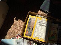 Box showing National Geographic magazines and other books inside.