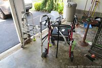 Overview of the lot showing all the mobility aids and commode chair