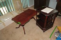 Photo showing both the vintage mahogany coffee table and the Bombay Company wood end table with carved sides and shelves