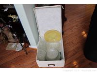 Set of clear and yellow Depression glassware including bowls, plates, serving dishes packed in a box.