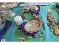 Coaster and letter opener on green cloth with purple pouch beneath coaster