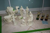 Full view of ceramic nativity figures with Murano glass figurines on tile floor