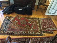 Three wool Persian rugs and one small Native American rug on hardwood floor, showing overall size and condition.