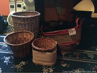 Group of five baskets and one thin-wood box on carpeted floor with various backgrounds
