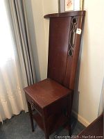 Wooden bed headboard with matching nightstand beside it, showing scratches and scuffs on surfaces.