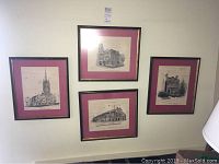 Photo showing all four framed pen and ink artworks arranged on a wall, each with dark red mats and wood frames.
