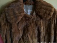 Close-up view of dense brown Persian Lamb fur coat with fur trim and label Austria Fur Winnipeg
