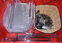 Clear plastic display shelves, metal and plastic slatwall hooks in basket plus long metal hanger hooks below