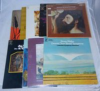 Nine classical music LP records arranged overlapping on a surface, showing front cover art including Dvořák's New World Symphony by Bruno Walter and others.