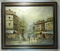 Full view of framed oil painting showing a city street scene with buildings, a large tree, and figures walking in the street.
