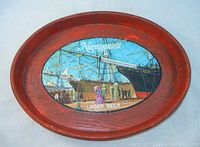 Top view of the oval serving tray showing the full vintage painted center with sailboats and people, surrounded by reddish wood-like plastic frame.