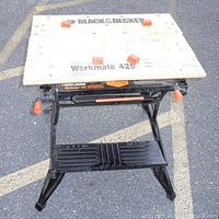 Front view of Black & Decker Workmate 425 with wooden tabletop and metal frame.