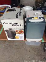 Hamilton Beach HealthSmart juice extractor box with Honeywell humidifier on top and storage bins underneath.