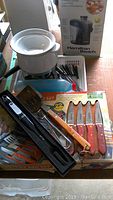 Full view of BBQ utensils, steak knives, and fondue set with box in background