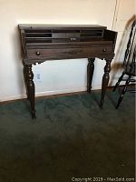 Full front view of vintage solid wood secretary desk closed