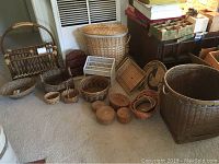 Front view confirming all baskets, magazine holder, trays in natural brown wicker/rattan material with cream lined large laundry basket.
