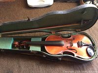 Wooden violin with ebony fingerboard and chinrest, horsehair bow, green-lined hard shell case open flat