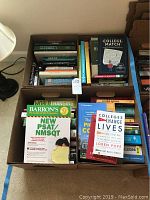 Top view of two boxes filled with various academic and test preparation books including SAT prep, algebra, and college guides.