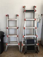 Two ladders side by side and step stool folded at base