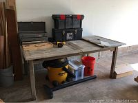 Wide view of workbench with two toolboxes, wooden screwdriver tray, DeWalt drill, Shop-Vac on floor