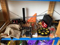 Wide view of wooden shelving with assorted hand tools laid out
