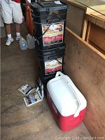 Three stacked Wise Company Emergency Food Supply buckets and red/white Igloo cooler visible
