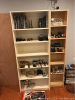 Books, tools, hobbyist items including electronics wire and solder, tools, small parts, and packaged items on shelves.