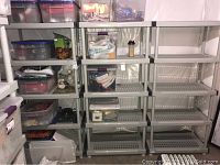 Full view of five shelving units with some filled shelving and some empty units