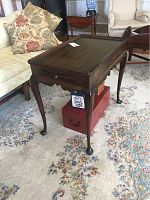Side table showing full length from side with visible curved legs and drawer knob.