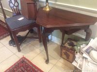 Full view of the square Henkel Harris table with drop sides and leg extension, showing polished wood surface and three fixed legs with one leg partially extended.