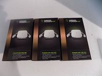 Three boxed Duracell PowerMat USB portable chargers showing front packaging with product image and branding.