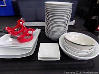 Stack of 23 round seven-inch white bowls, four larger platters, two small square plates, three red T-Fal corers.
